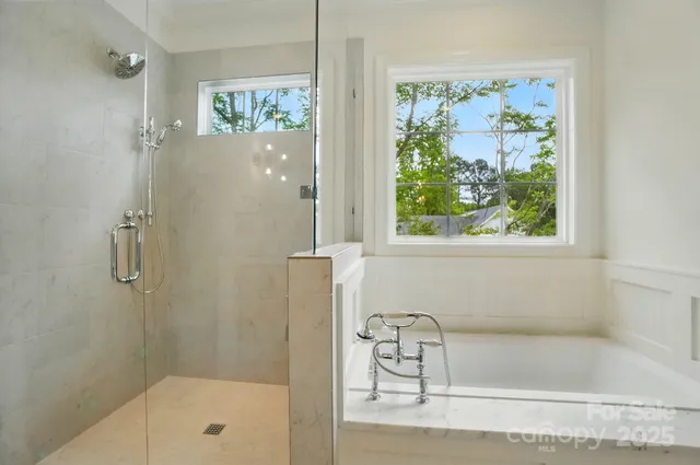 a bathroom with a bathtub and a shower