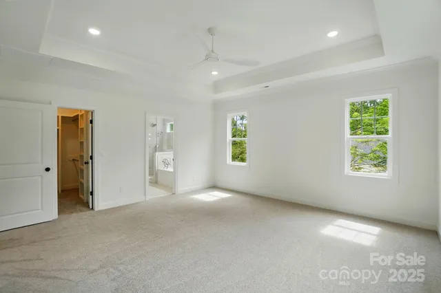 an empty room with windows and closet