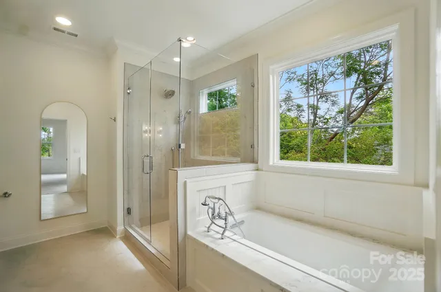 a bathroom with a bathtub and a shower