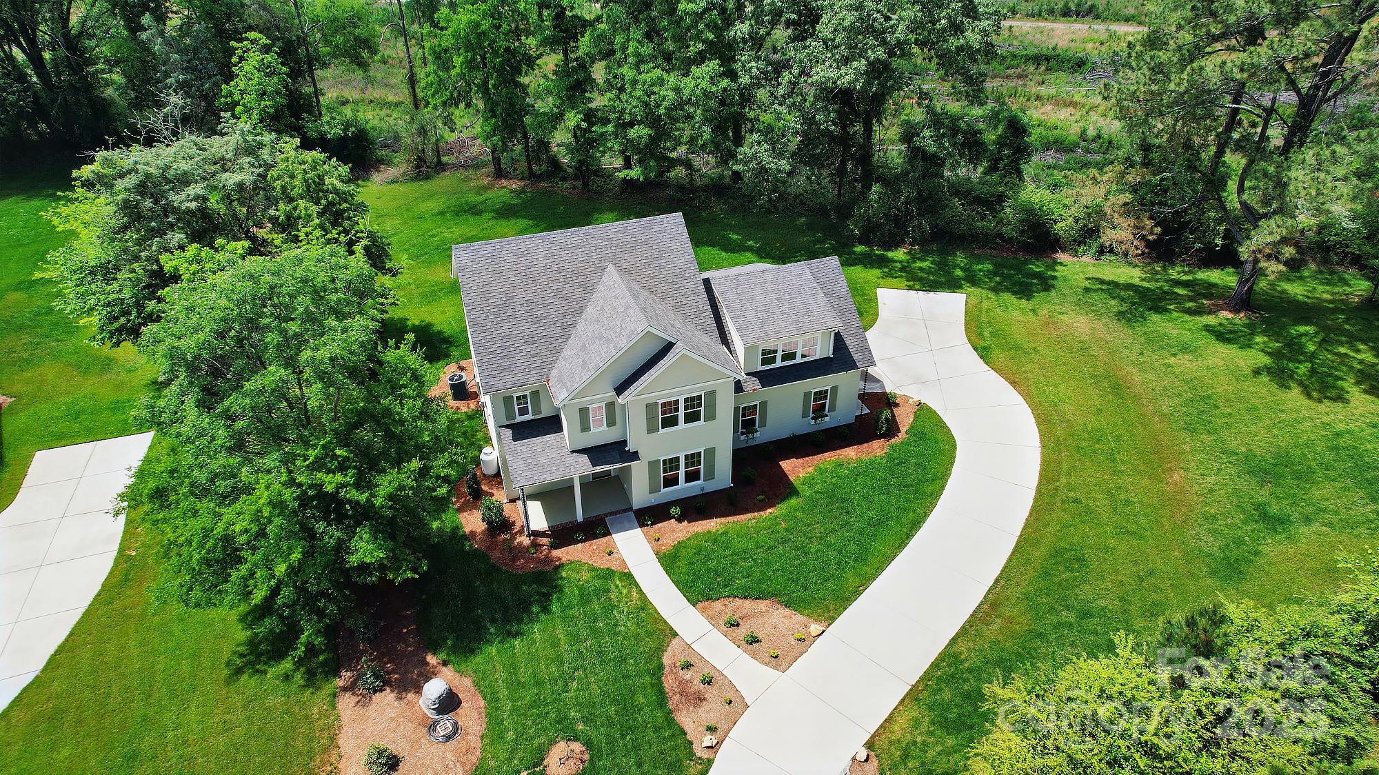 9315 Simpson Road Waxhaw, NC 28173 - Photo 3 of 45 aerial view of a house with a big yard potted plants and large trees