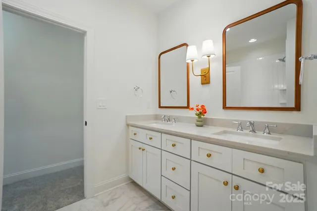 a bathroom with a double vanity sink and mirror