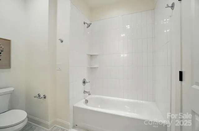 a bathroom with a bathtub and a toilet