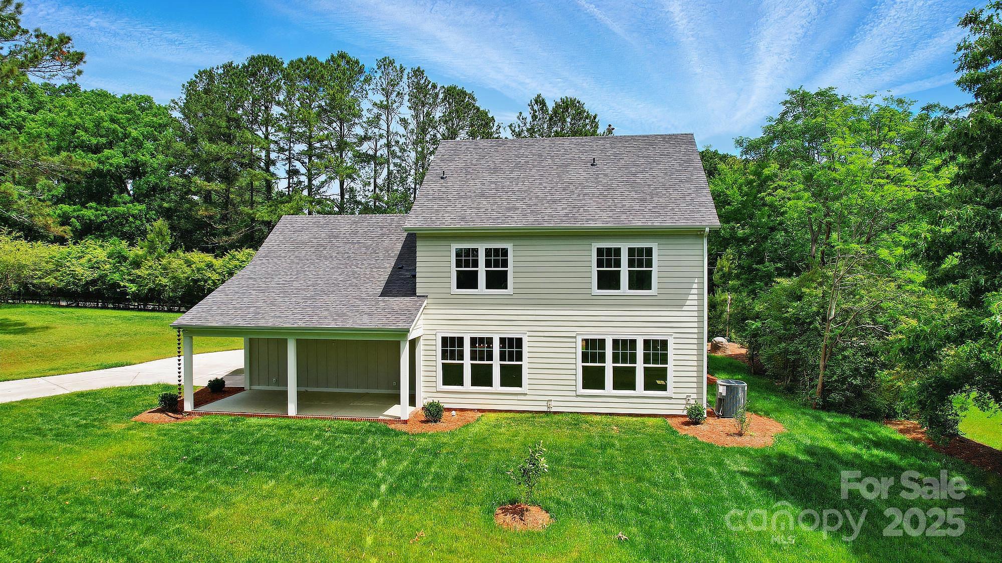 9315 Simpson Road Waxhaw, NC 28173 - Photo 4 of 45 a front view of a house with a yard table and chairs