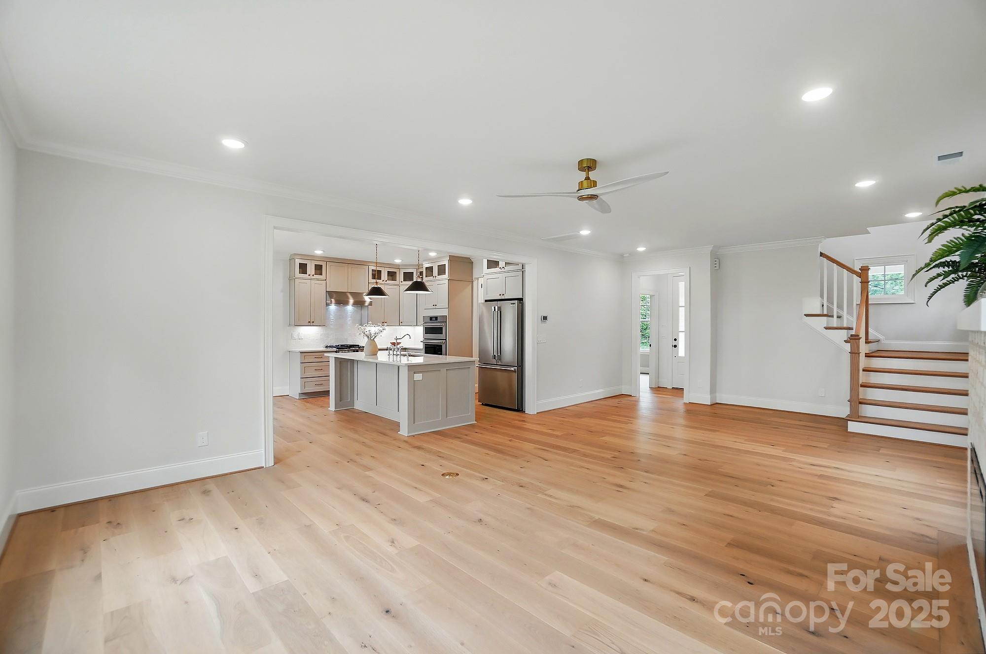 9315 Simpson Road Waxhaw, NC 28173 - Photo 9 of 45 a view of kitchen with refrigerator and wooden floor