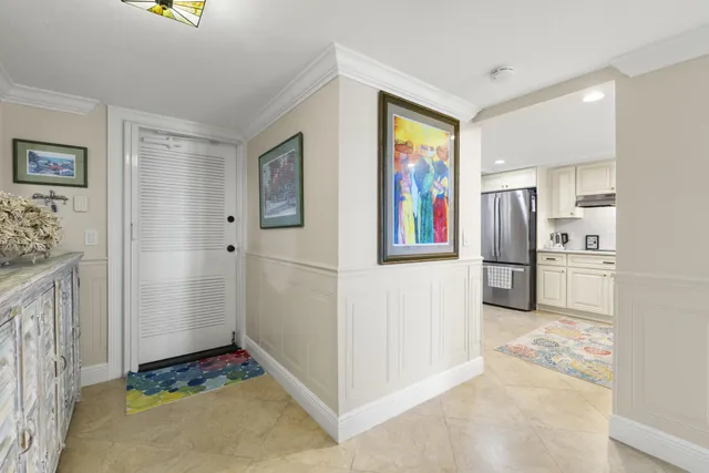a view of a kitchen with fridge and wooden floor