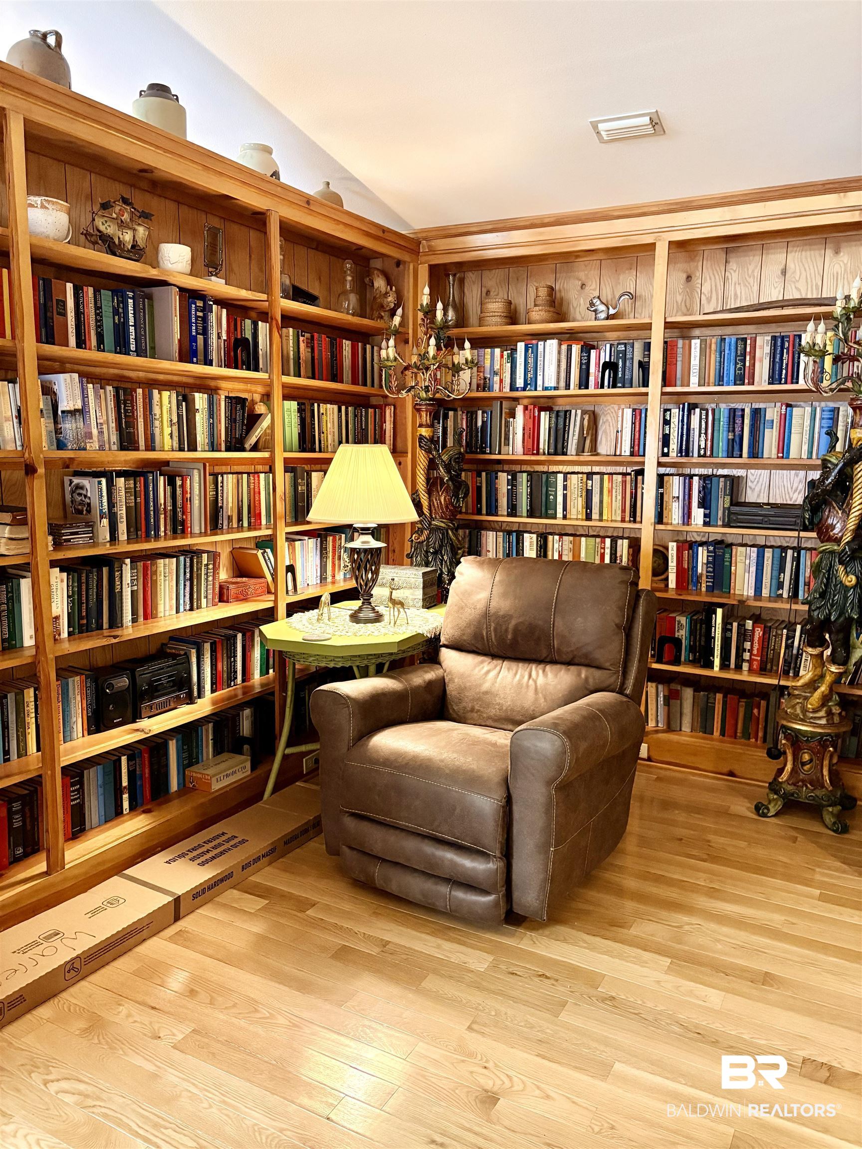 44 Ridge Road Castleberry, AL 36432 - Photo 12 of 33 Living area with wall of books and light wood-style floors