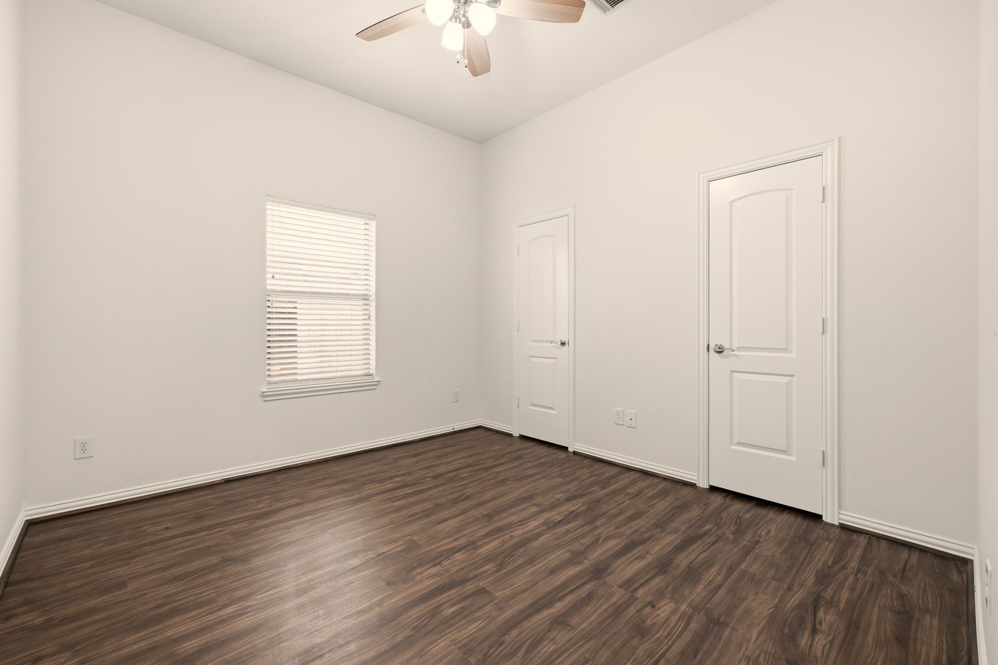 25207 Oak Star Drive Spring, TX 77389 - Photo 12 of 18 an empty room with wooden floor chandelier fan and windows