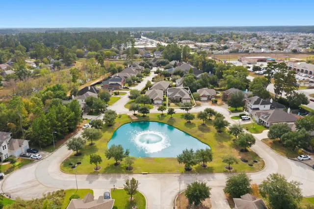 an aerial view of residential houses with outdoor space and swimming pool