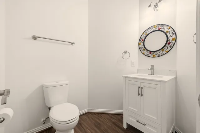 a bathroom with a toilet a sink and a mirror