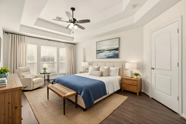 a bedroom with a bed and a chandelier