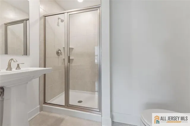 a bathroom with a shower and a sink