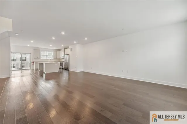 a view of kitchen and hall with wooden floor