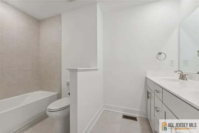 a bathroom with a sink a toilet and a window