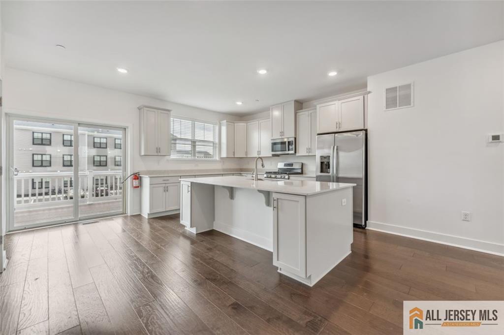 46 Mariveles Way Eatontown, NJ 07724 - Photo 4 of 26 a kitchen with a refrigerator and a stove top oven