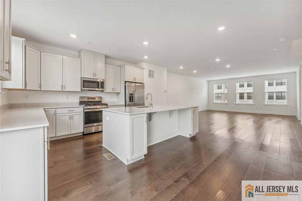 46 Mariveles Way Eatontown, NJ 07724 - Photo 8 of 26 a kitchen with white cabinets and appliances