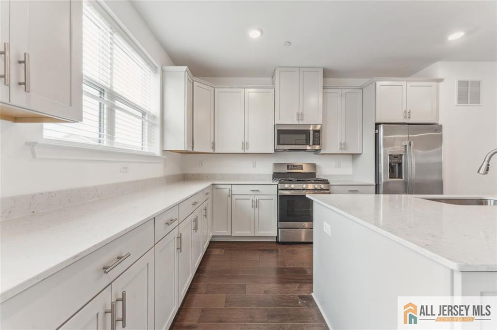 46 Mariveles Way Eatontown, NJ 07724 - Photo 9 of 26 a kitchen with cabinets appliances a sink and a window