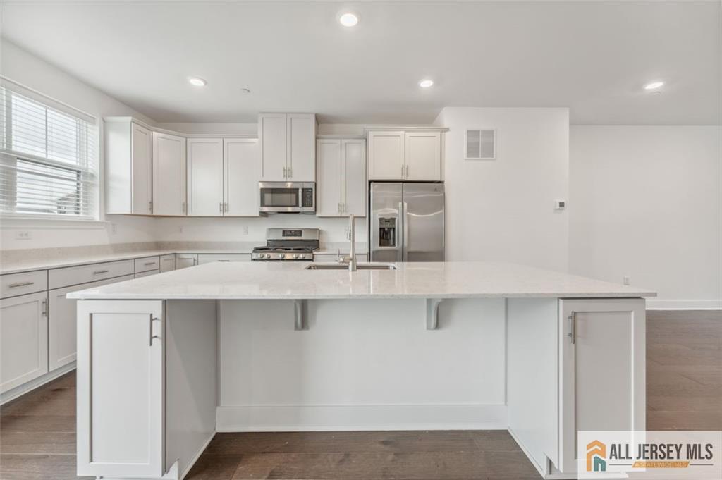 46 Mariveles Way Eatontown, NJ 07724 - Photo 10 of 26 a kitchen with stainless steel appliances granite countertop a sink a stove a refrigerator and white cabinets