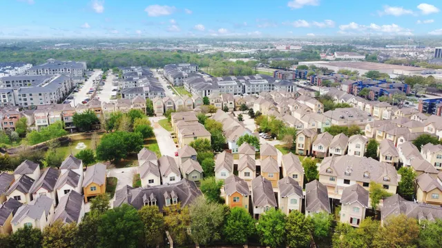 an aerial view of residential houses with outdoor space