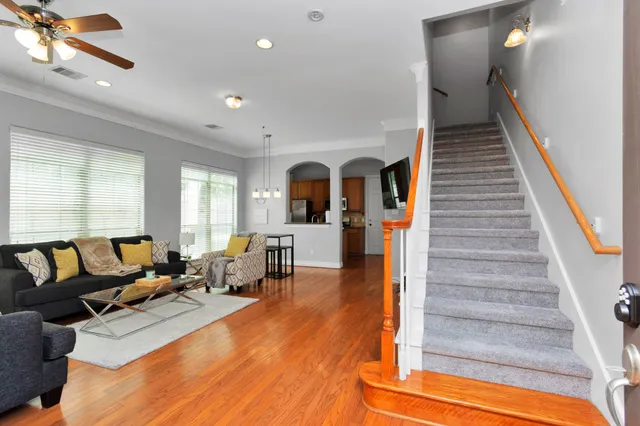 a living room with furniture and wooden floor