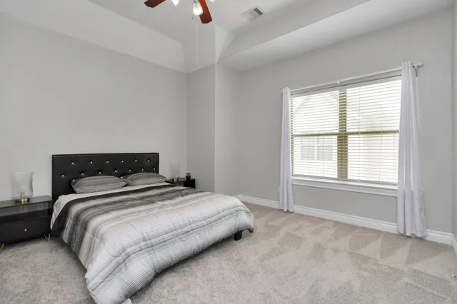 a bedroom with a bed and a window