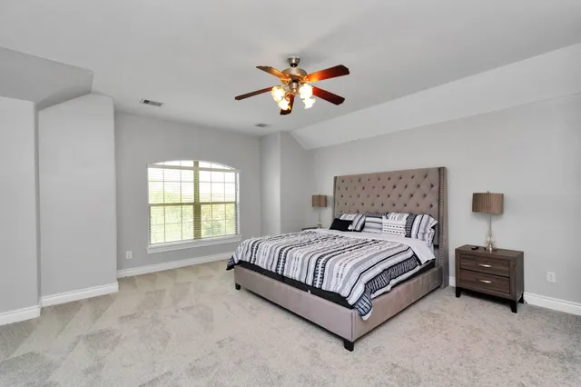 a bedroom with a bed and a chandelier