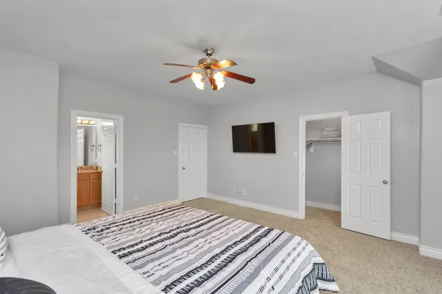 a bedroom with a bed and a chandelier