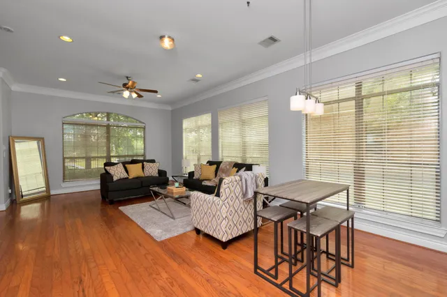 a living room with furniture and wooden floor