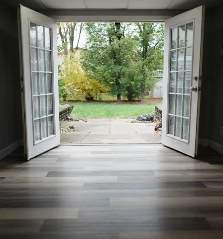 a view of porch with a floor to ceiling window and wooden floor