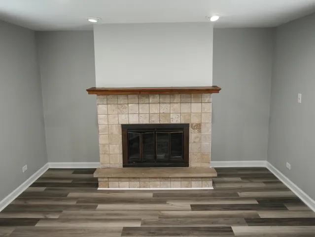 a living room with a fireplace and a fireplace