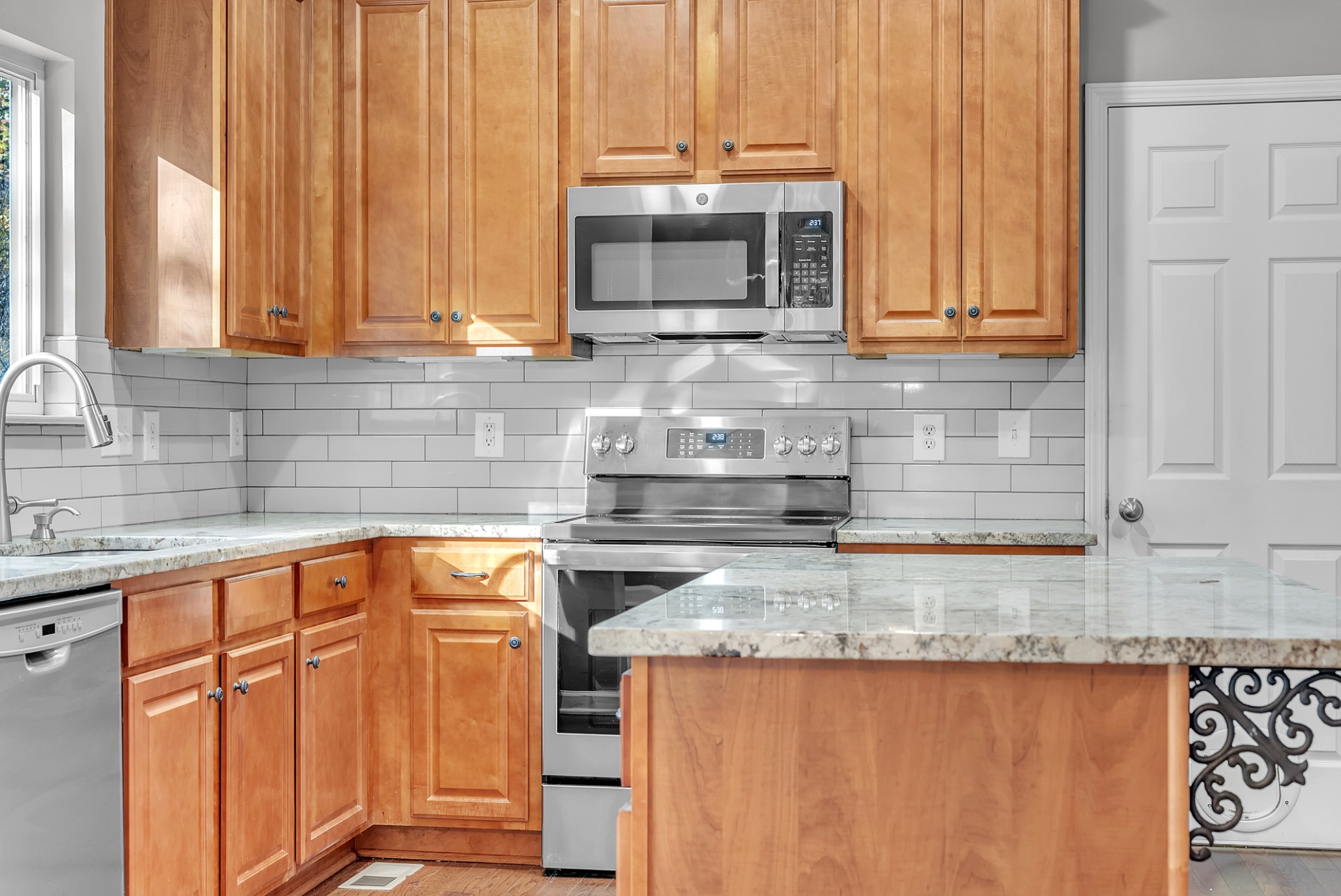 3924 Signature Court Smyrna, TN 37167 - Photo 6 of 35 a kitchen with stainless steel appliances granite countertop a sink a microwave cabinets and a stove top oven