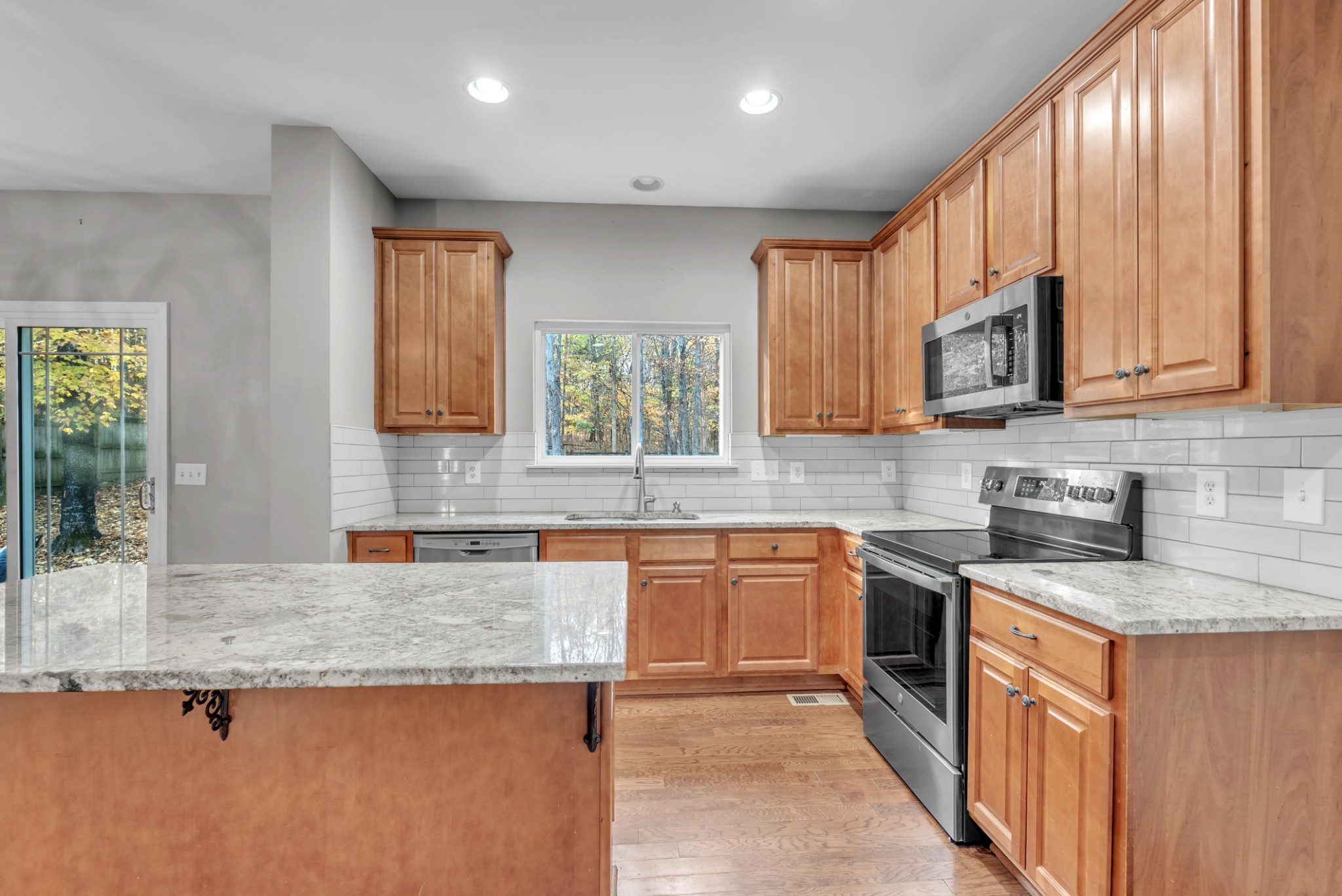 3924 Signature Court Smyrna, TN 37167 - Photo 7 of 35 a kitchen with stainless steel appliances granite countertop sink stove top oven and cabinets