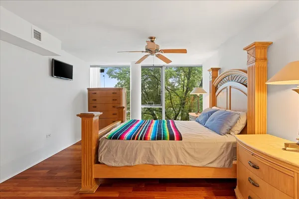 a bedroom with a bed and a flat screen tv