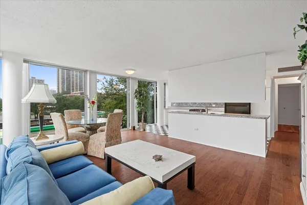 a living room with furniture a large window and a table