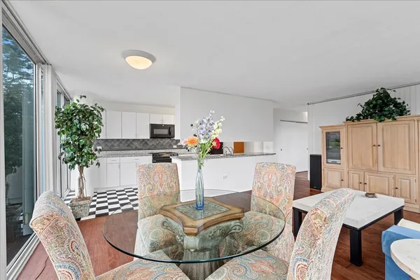 a living room with furniture a dining table and chairs
