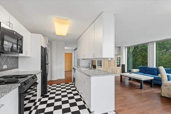 a kitchen with a stove a sink and a refrigerator