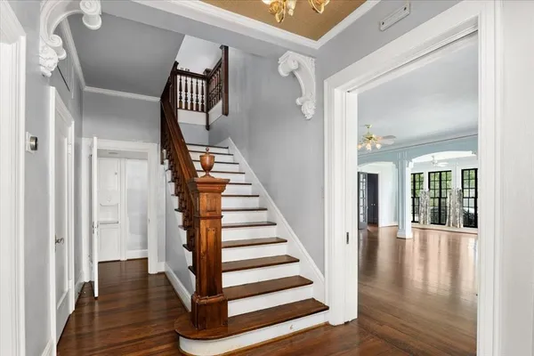 a view of staircase with wooden floor and a window