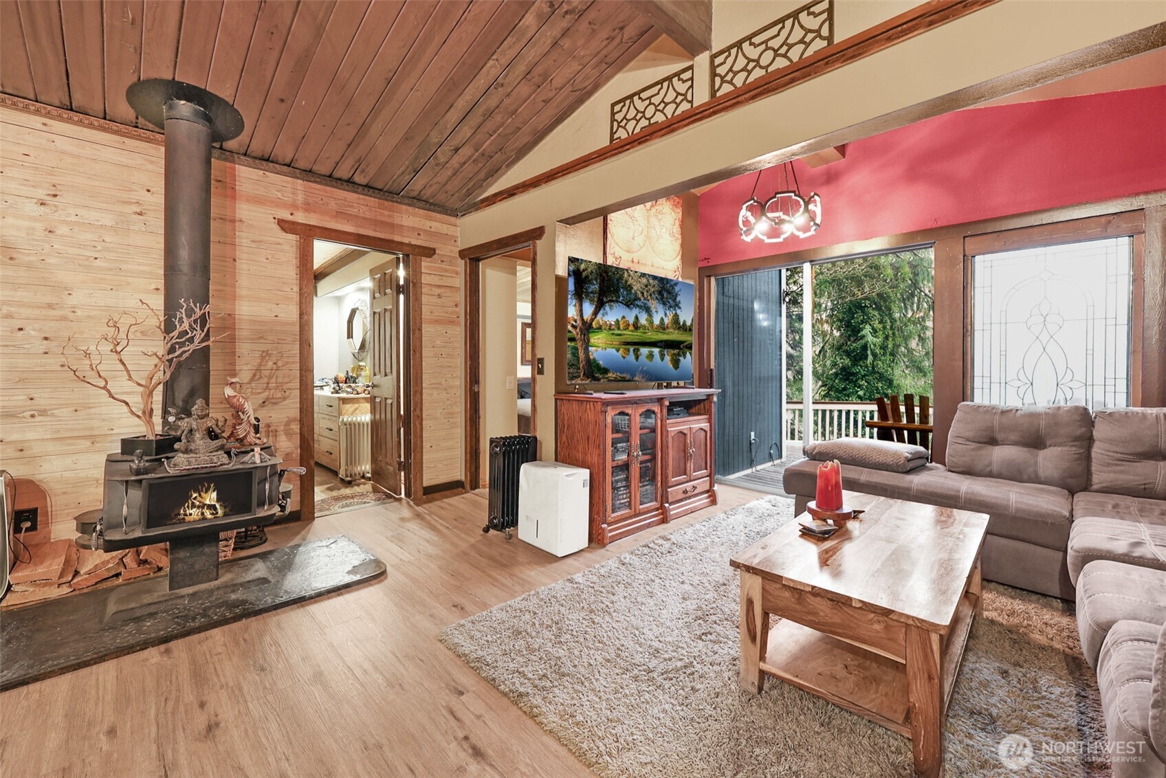 13109 Crystal Springs Road Granite Falls, WA 98252 - Photo 24 of 32 a living room with furniture a flat screen tv and floor to ceiling window