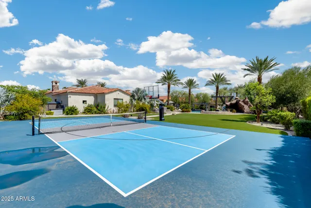 a media room with lots of chairs and a wooden floor