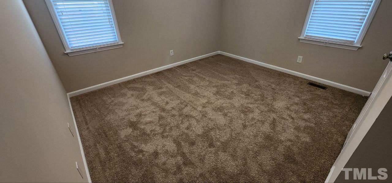 745 Brewer Circle Wake Forest, NC 27587 - Photo 13 of 18 an empty room with windows