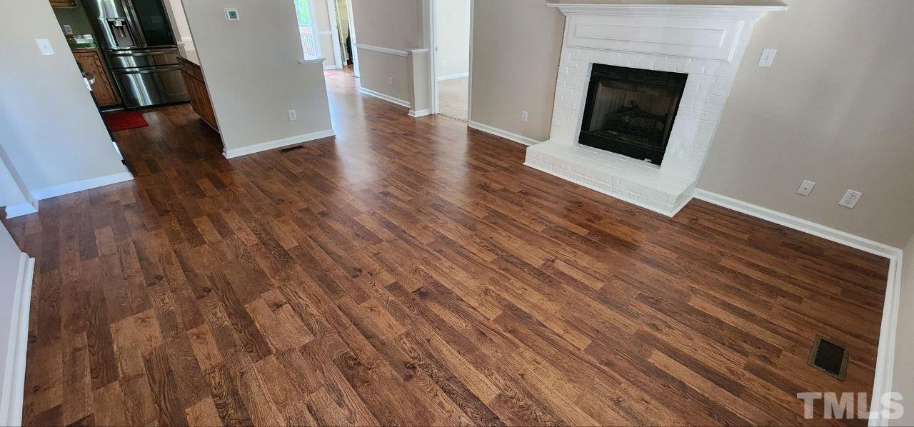 745 Brewer Circle Wake Forest, NC 27587 - Photo 17 of 18 a view of a livingroom with wooden floor and a fireplace