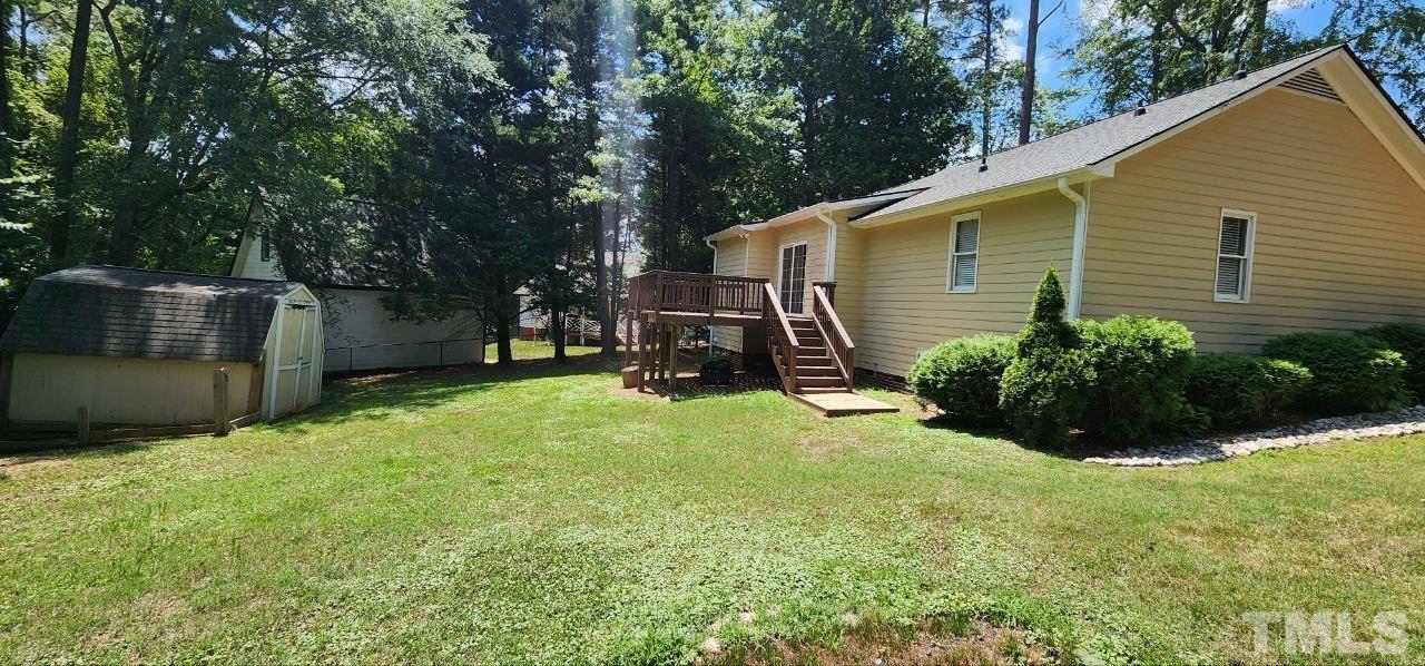 745 Brewer Circle Wake Forest, NC 27587 - Photo 5 of 18 a view of backyard with potted plants and a large tree