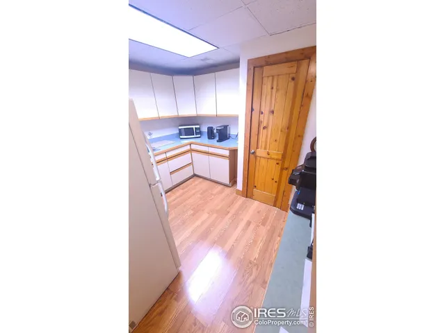 a kitchen with a refrigerator and window