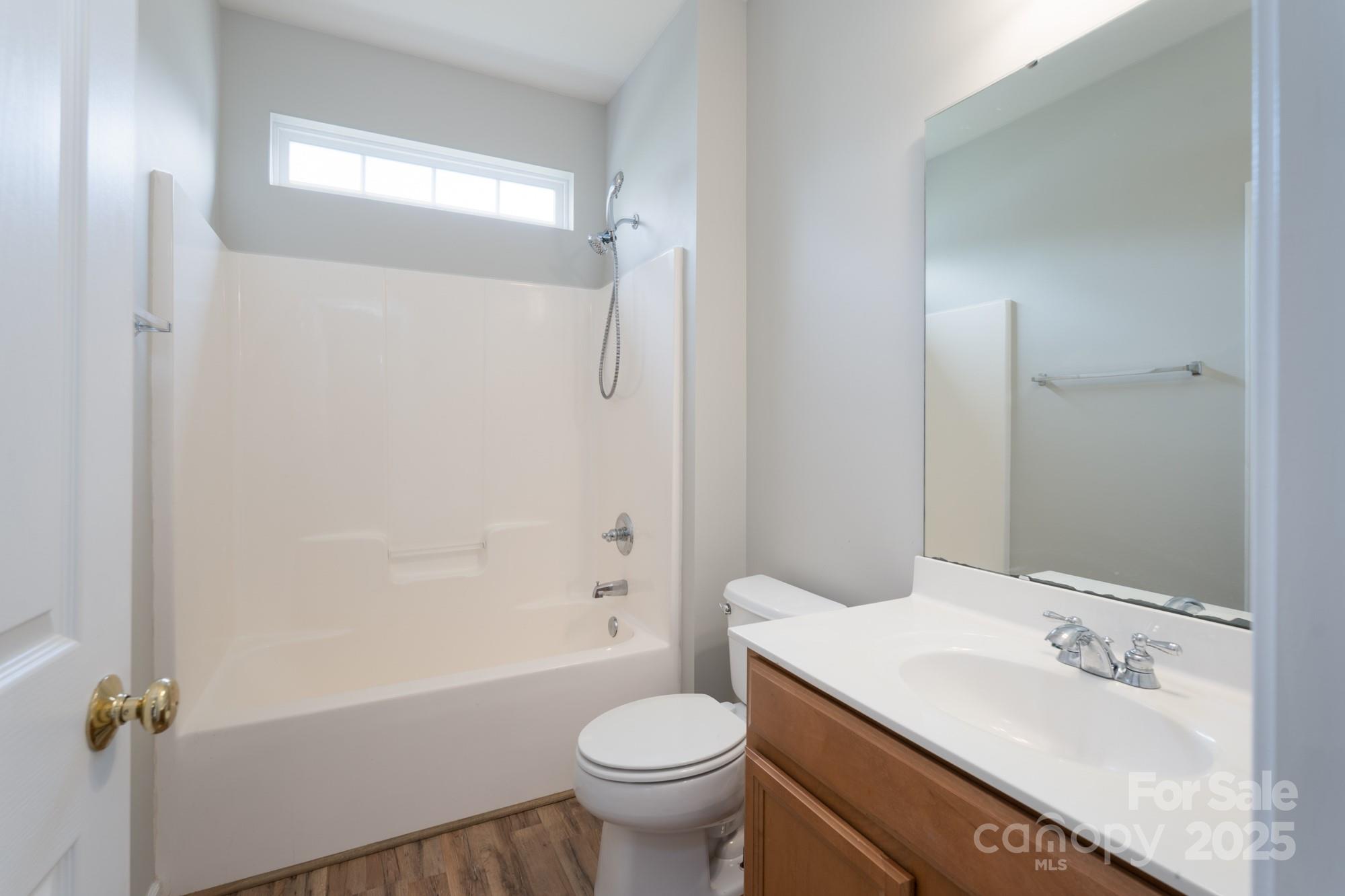4392 Sunset Rose Drive Fort Mill, SC 29708 - Photo 13 of 39 a bathroom with a sink toilet mirror vanity and shower