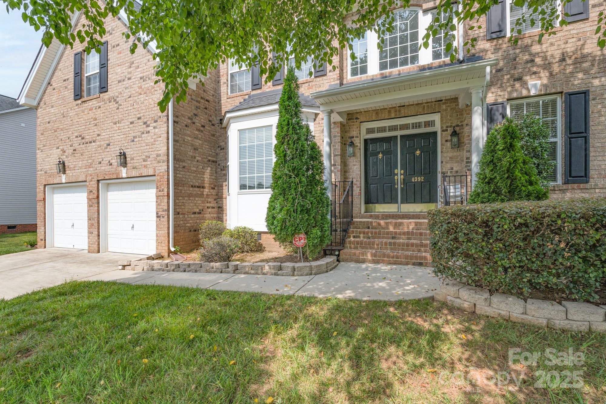 4392 Sunset Rose Drive Fort Mill, SC 29708 - Photo 2 of 39 a front view of a house with garden