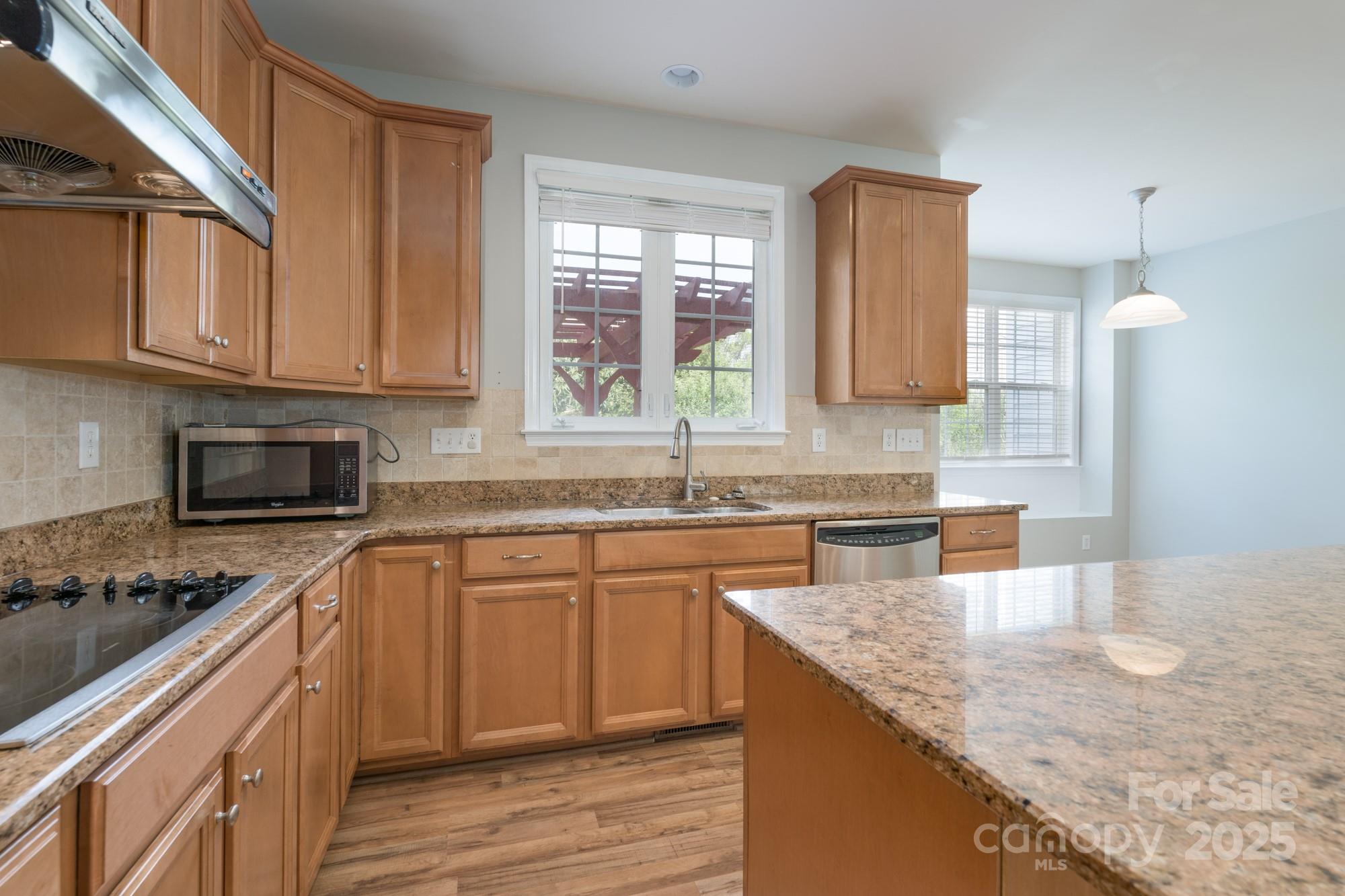 4392 Sunset Rose Drive Fort Mill, SC 29708 - Photo 5 of 39 a kitchen with stainless steel appliances granite countertop a sink stove and cabinets