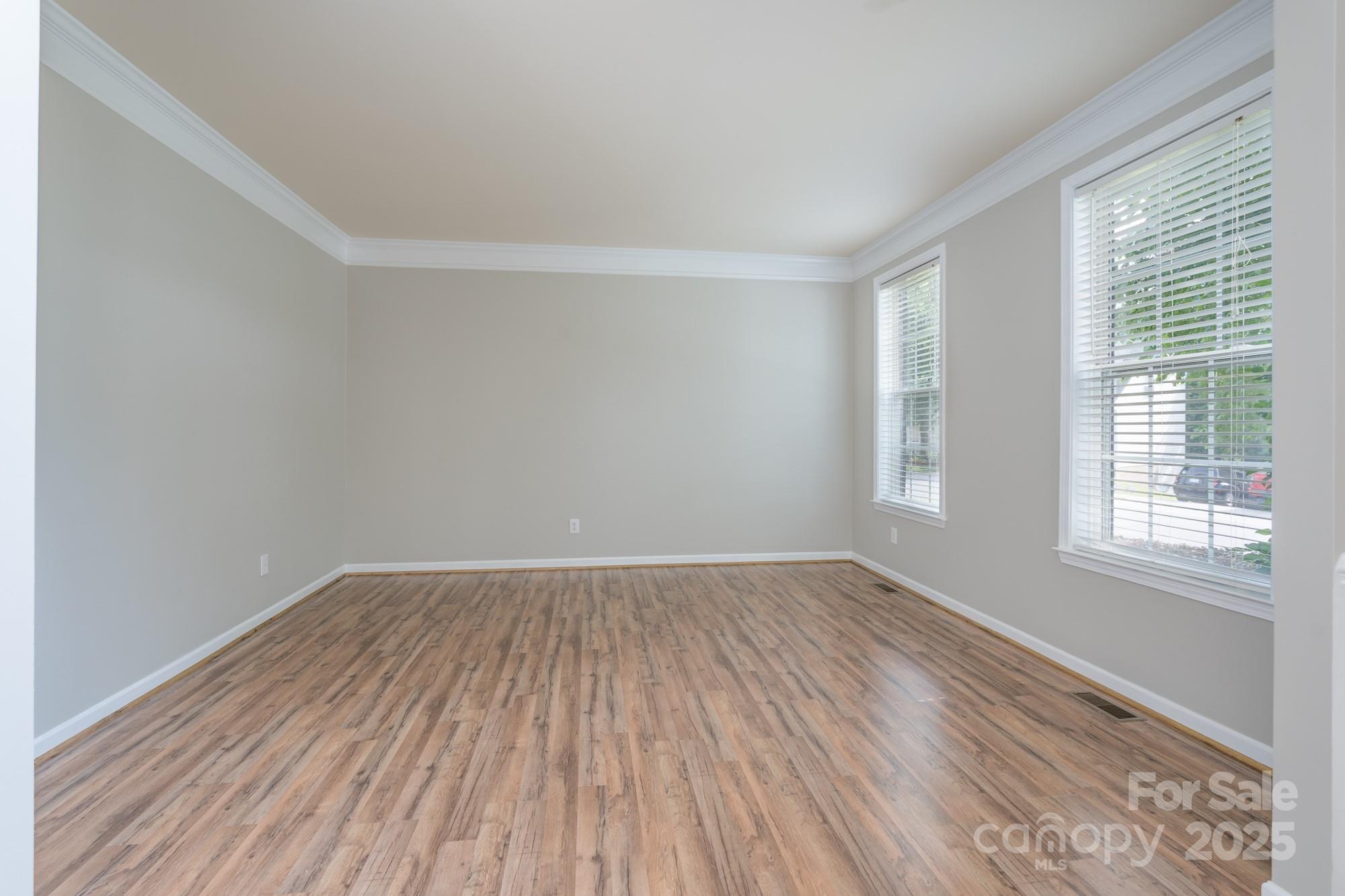 4392 Sunset Rose Drive Fort Mill, SC 29708 - Photo 10 of 39 an empty room with wooden floor and windows
