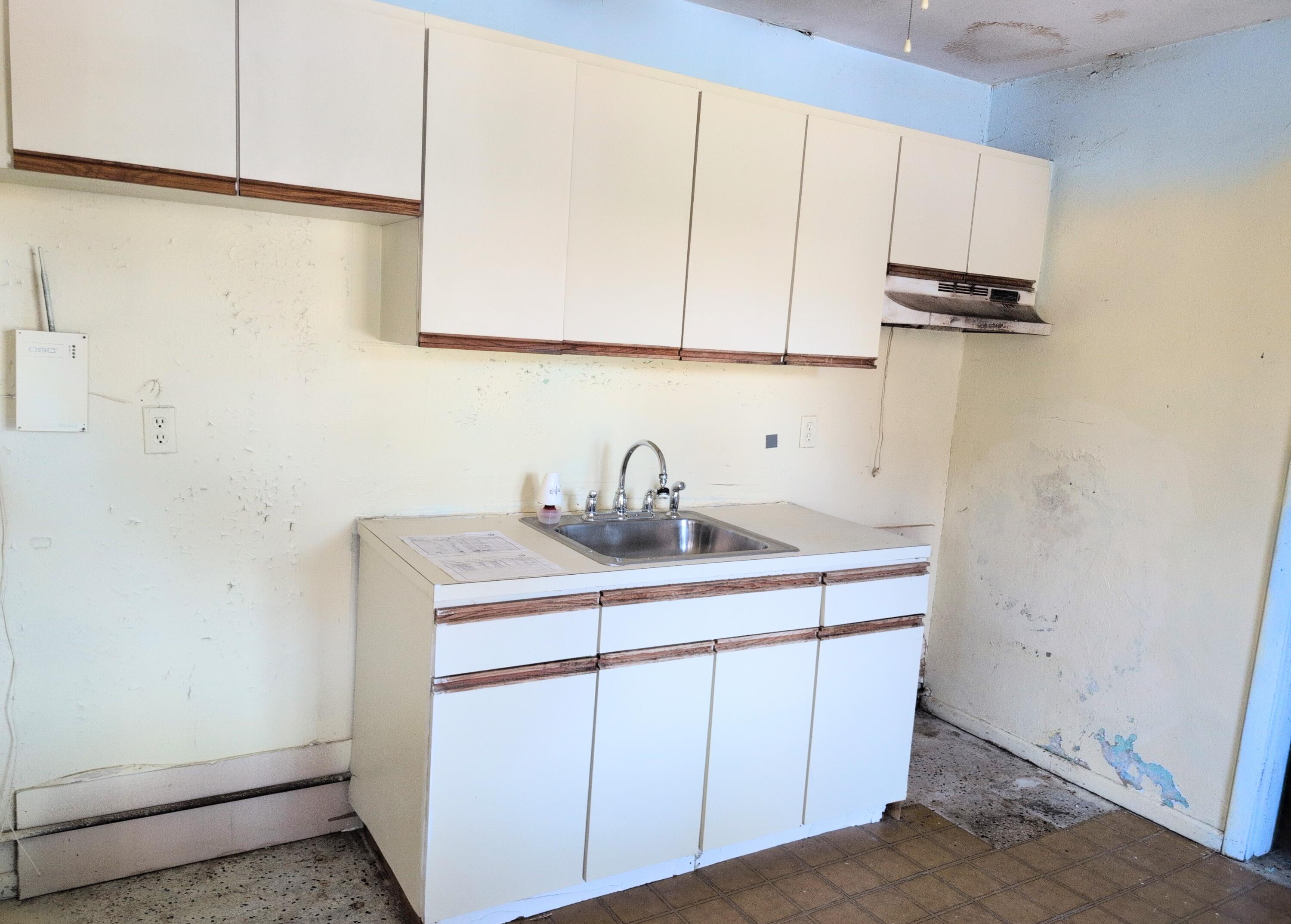 1606 Ave H Fort Pierce, FL 34950 - Photo 4 of 9 a kitchen with a sink and cabinets