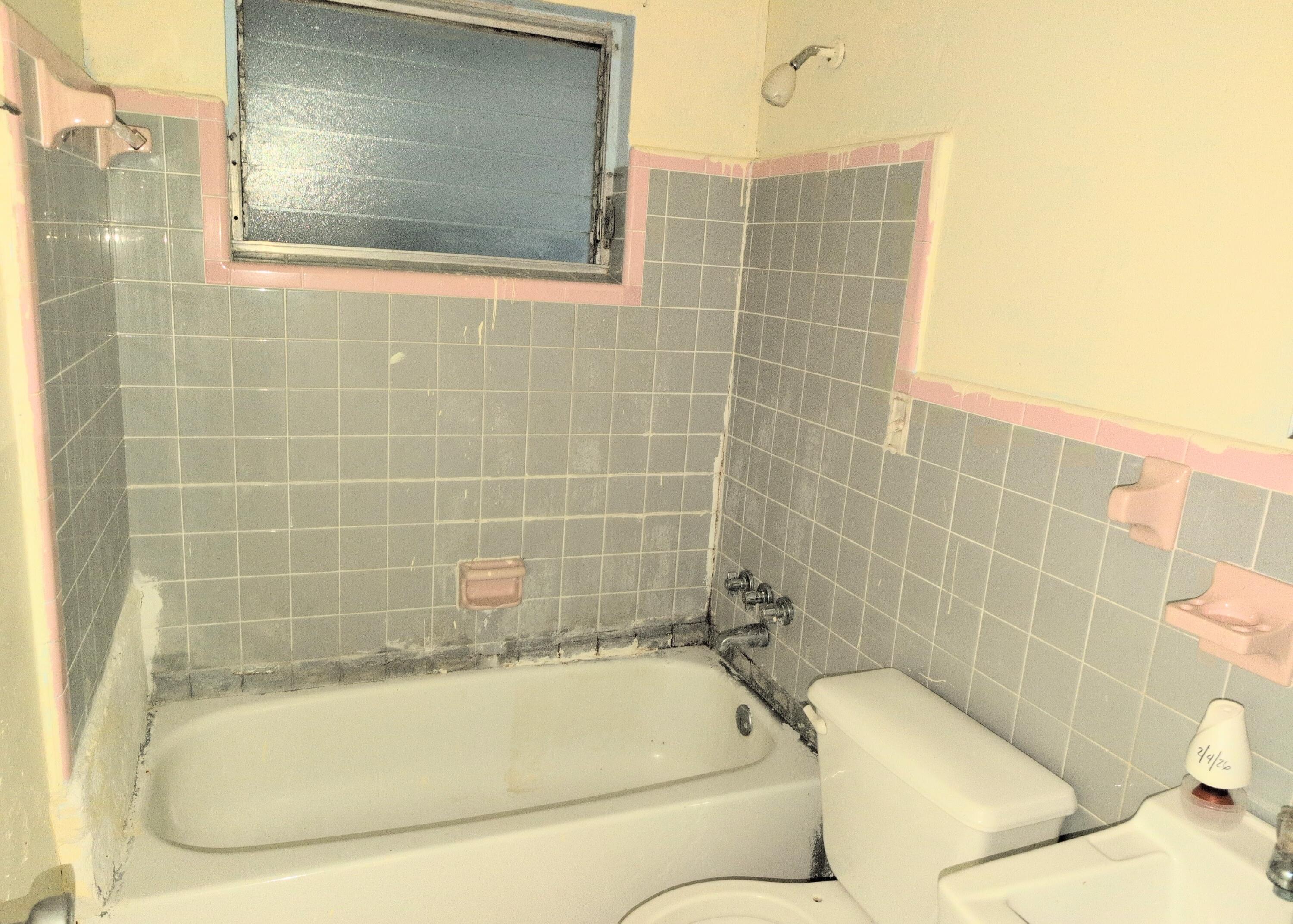 1606 Ave H Fort Pierce, FL 34950 - Photo 6 of 9 a bathroom with a bathtub and a shower