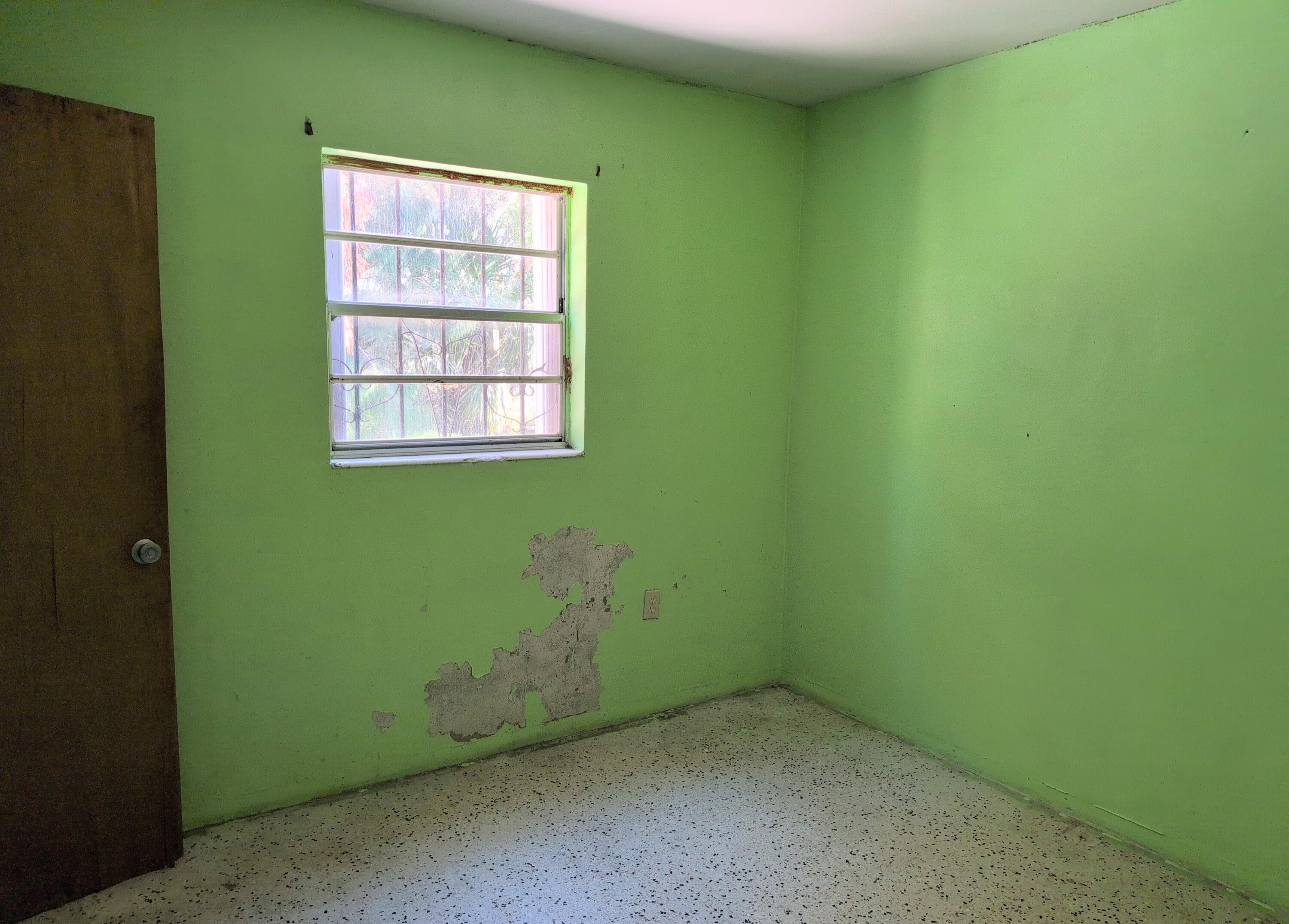 1606 Ave H Fort Pierce, FL 34950 - Photo 7 of 9 an empty room with a window and closet