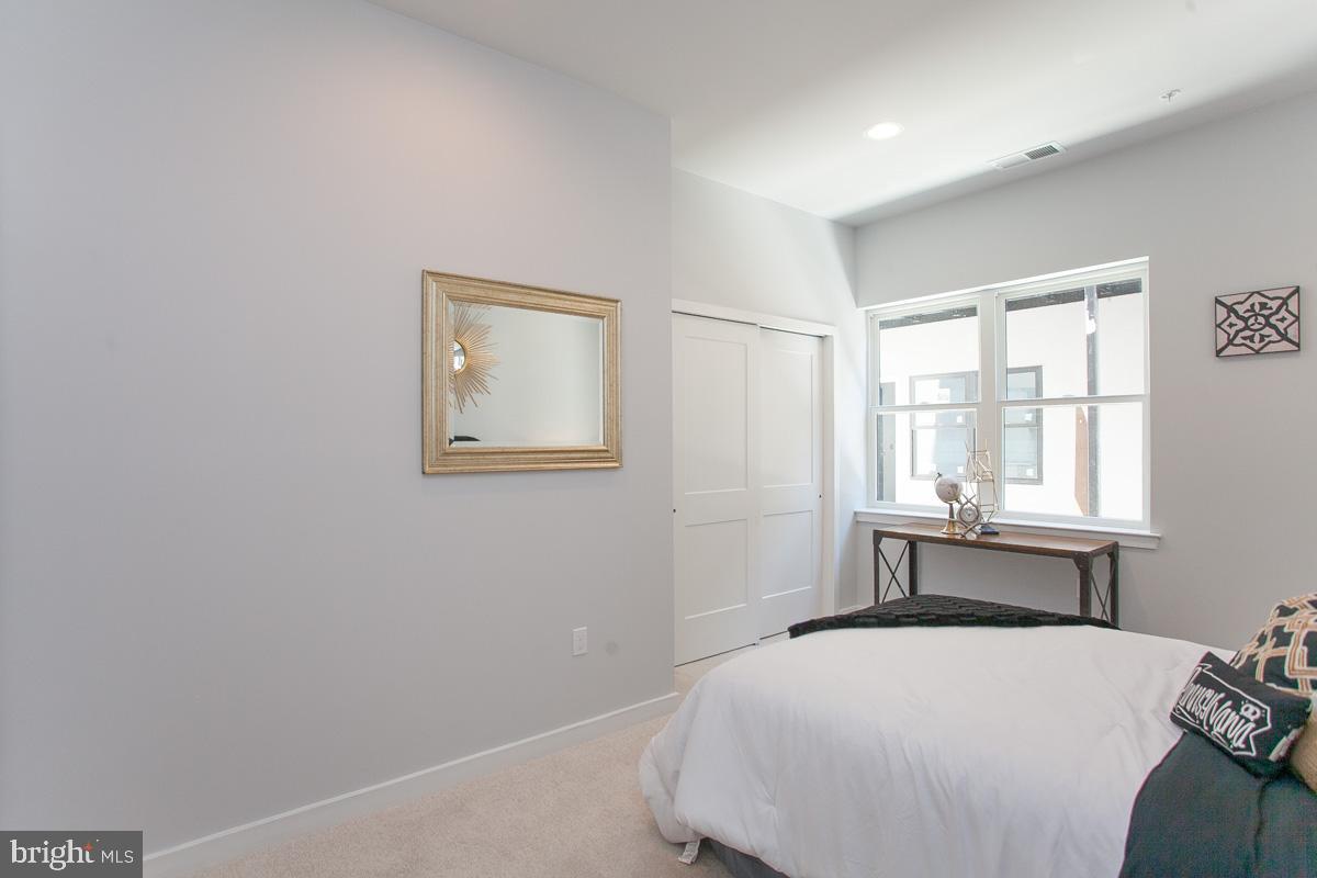 5938 Henry Avenue, Unit 21 Philadelphia, PA 19128 - Photo 12 of 19 a bedroom with a bed and a window